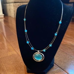 Silver necklace with aqua colored beads and pendant.